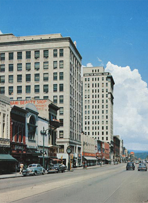 a street with cars and buildings