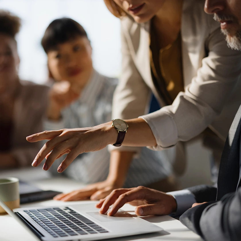 a man and woman looking at a laptop
