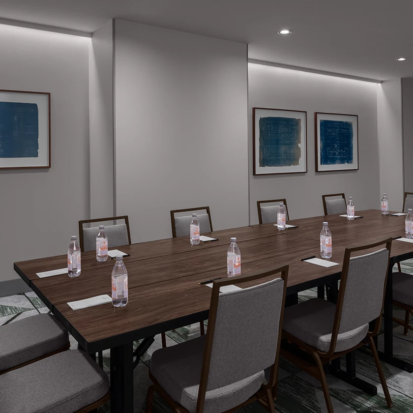 a conference room with a table and chairs
