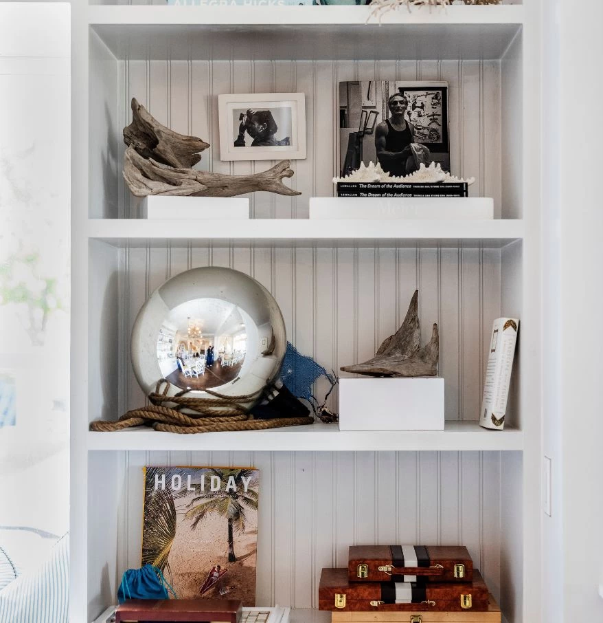 a white shelf with objects on it