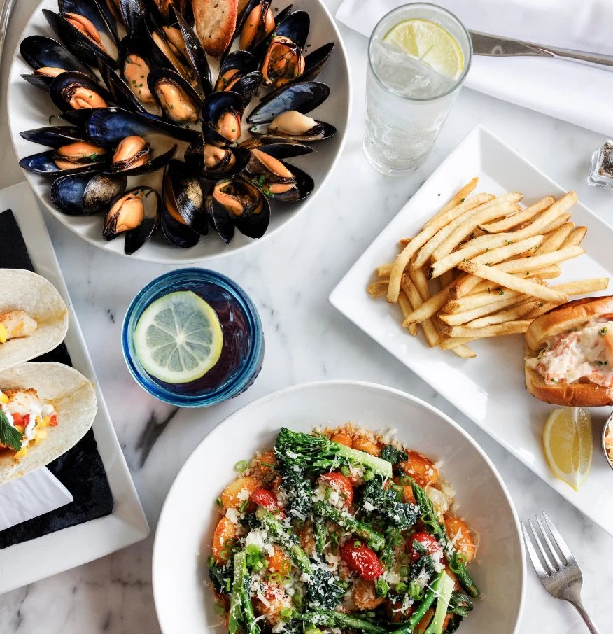a table with plates of food and drinks