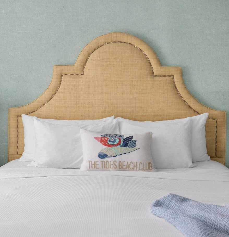a bed with pillows and a blanket on it