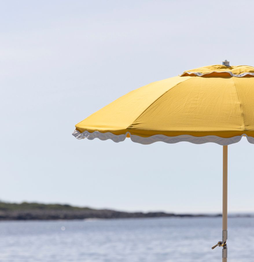 a yellow umbrella on a beach
