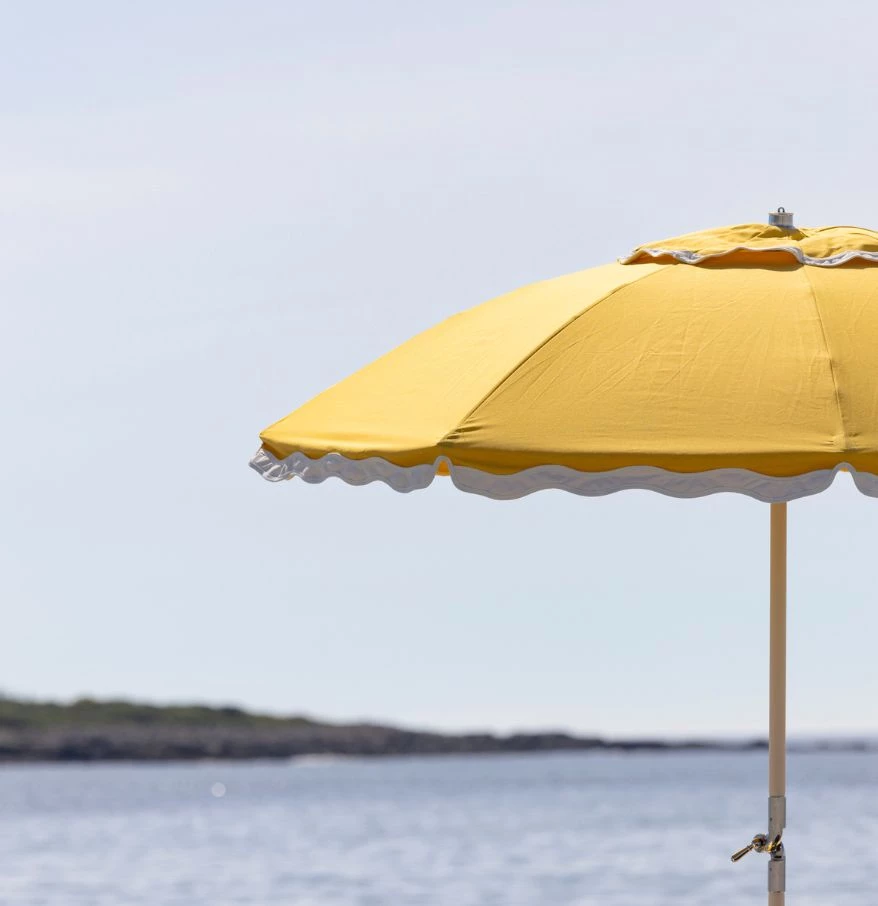 a yellow umbrella on a beach