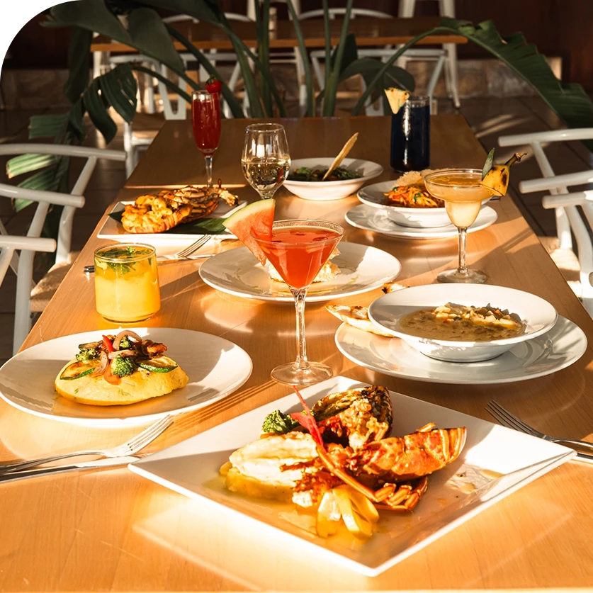 a table with plates of food and drinks