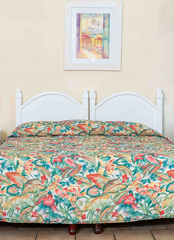 a bed with a floral comforter