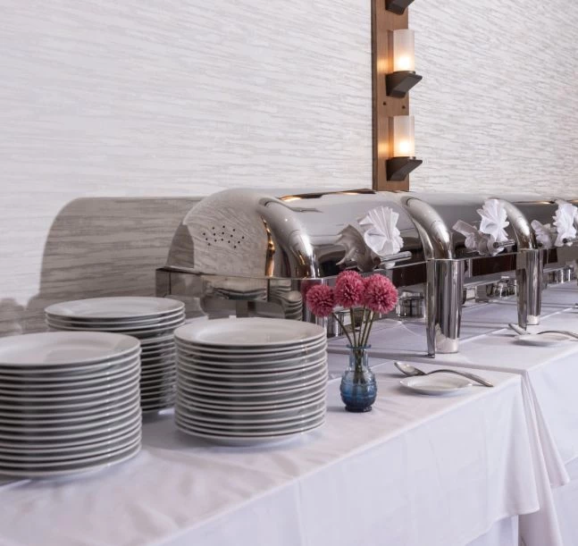 a buffet table with plates and silverware