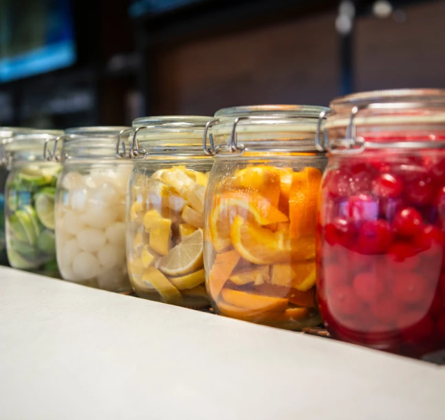 jars of fruit and vegetables in a row