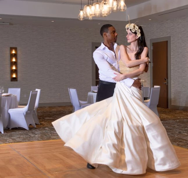 a man and woman dancing in a room