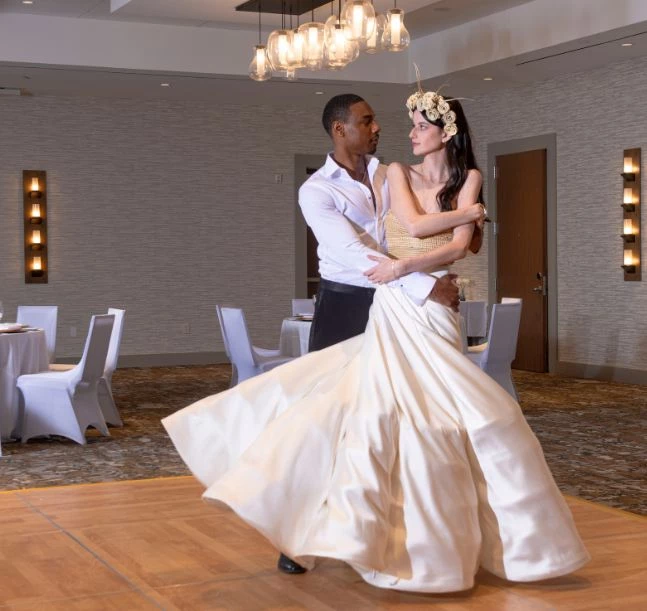 a man and woman dancing in a room
