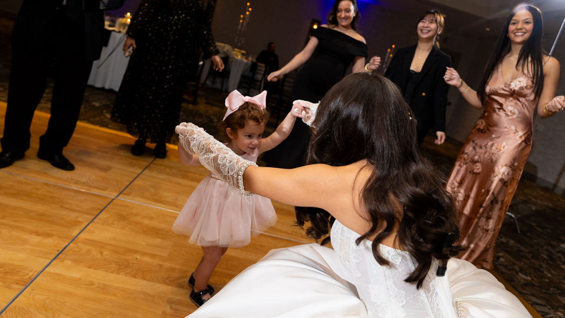 a woman in a white dress and a little girl in a pink dress