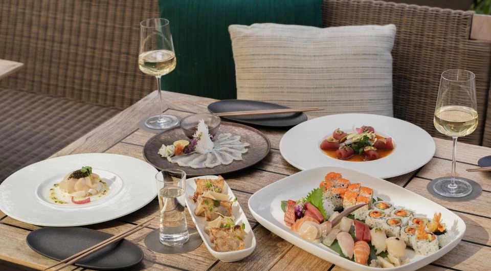 a table with plates of food and glasses of wine