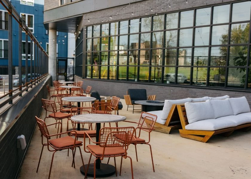 A rooftop patio with outdoor seating and a fire pit