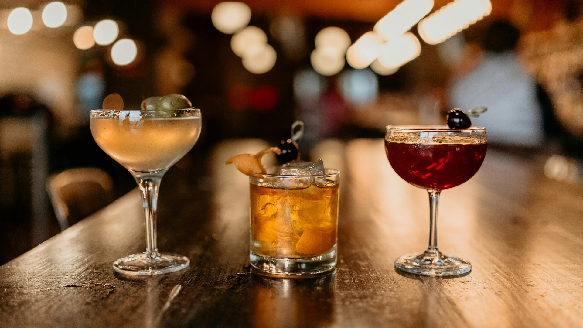 three cocktails on a bar