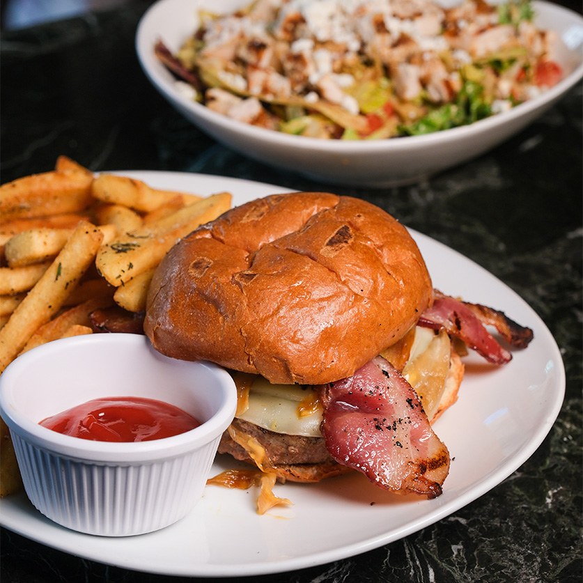 a plate of food with a side of salad and a burger