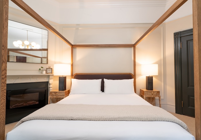 a bed next to a fire place