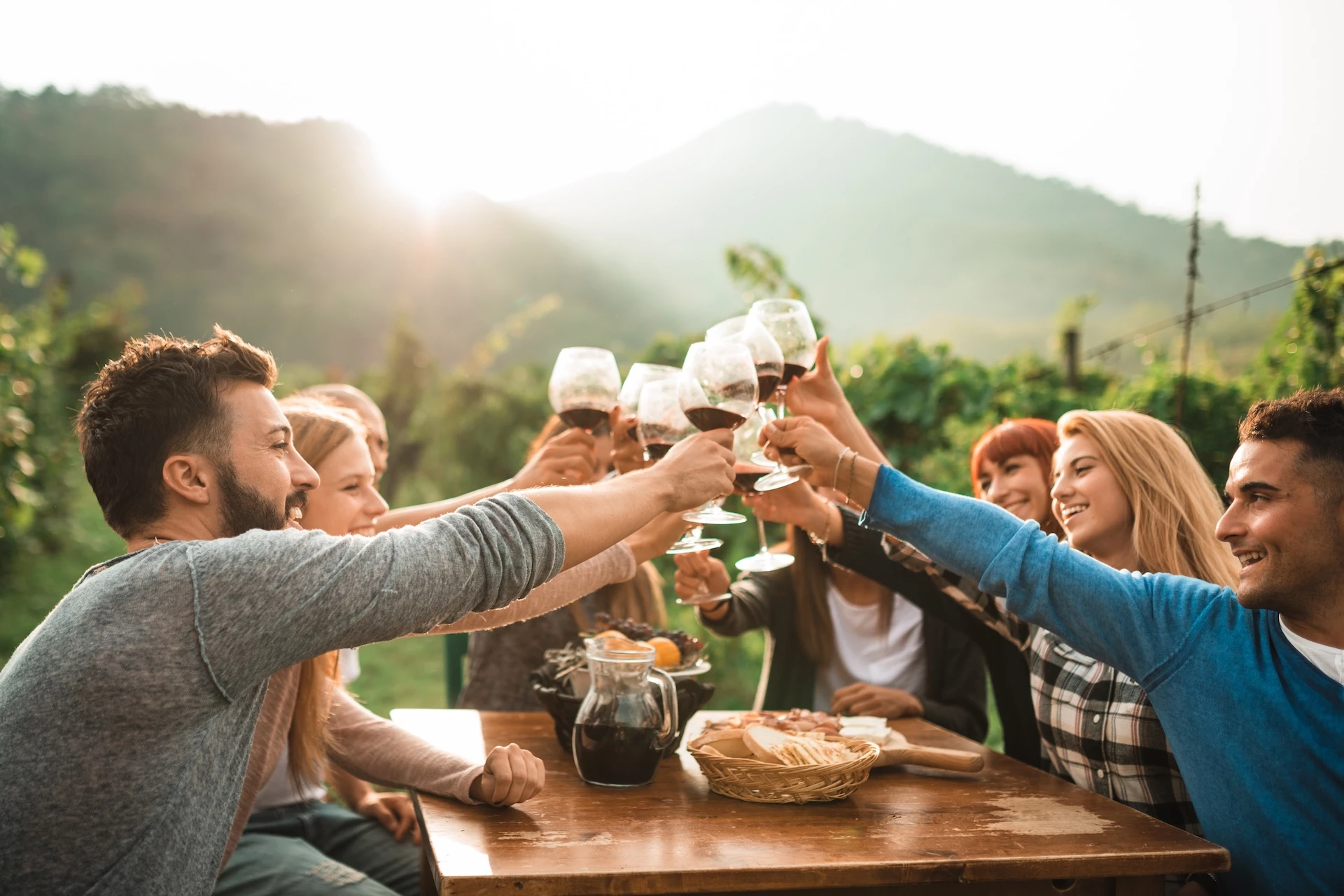 a group of people clinking wine glasses at a table