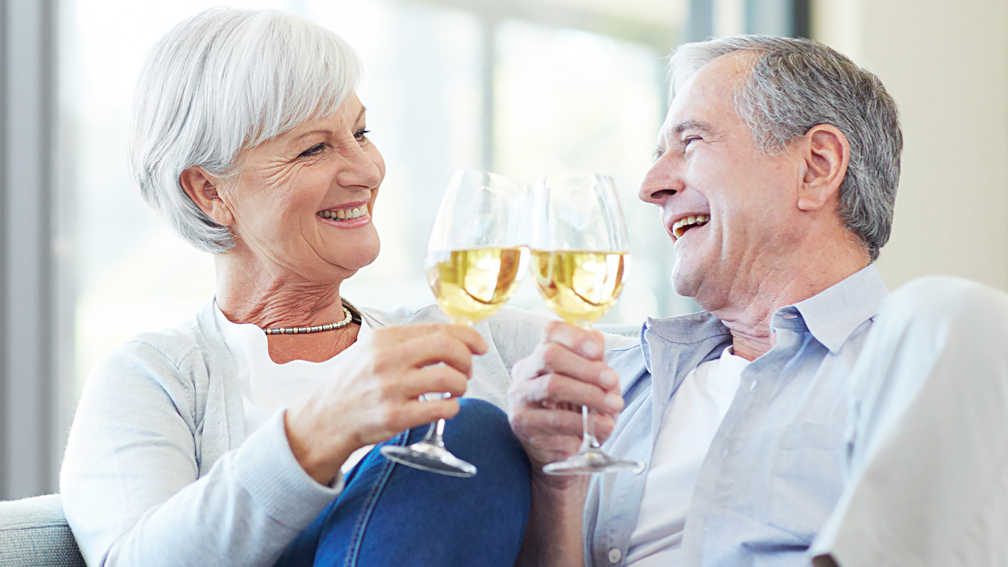 a man and a woman holding wine glasses