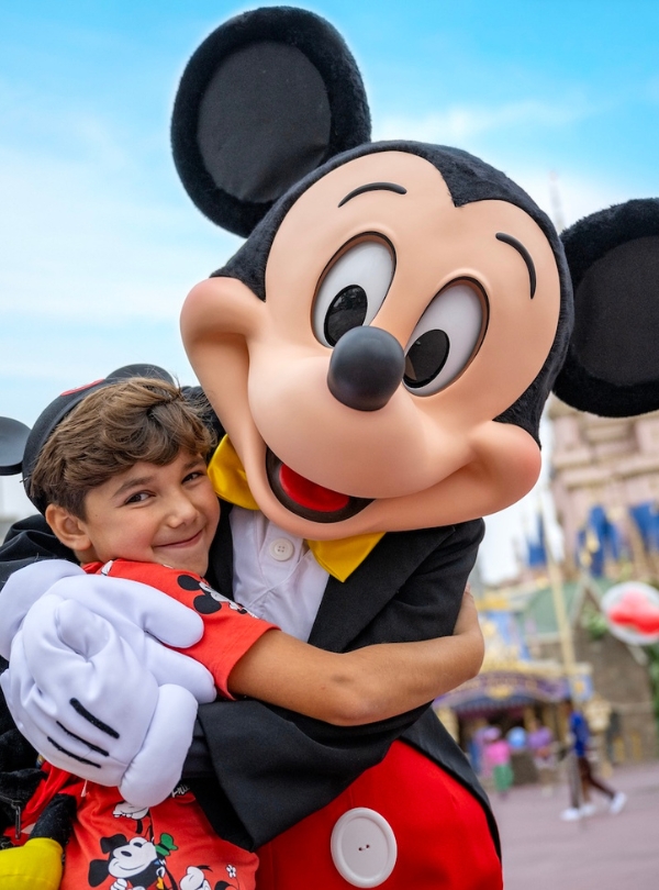 a boy hugging a person in a garment