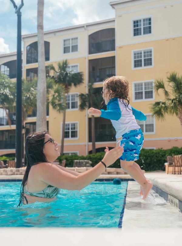 a woman and child in a pool