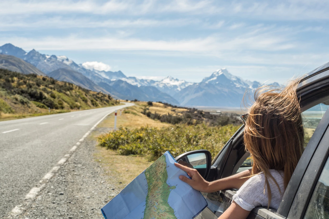 a woman looking out of a car window with a map