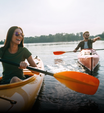 a man and woman in kayaks