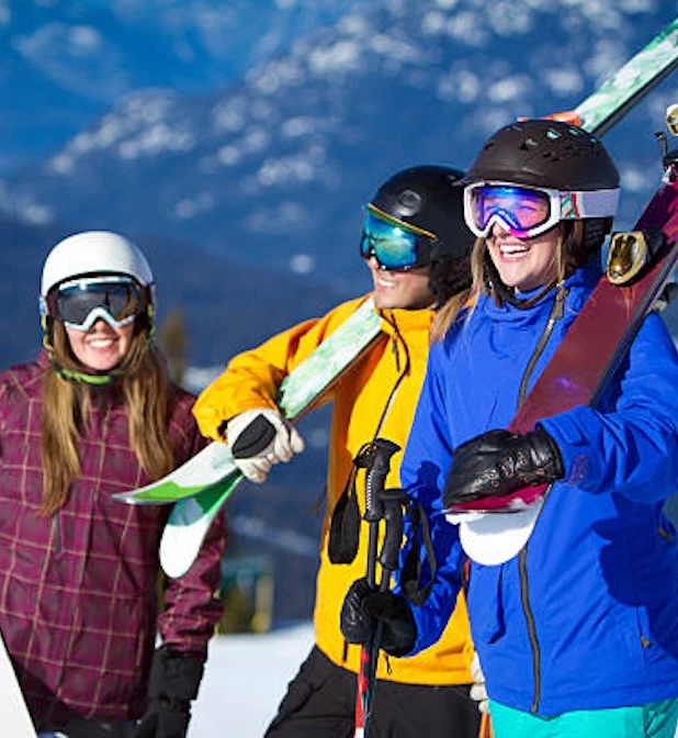 a group of people holding skis