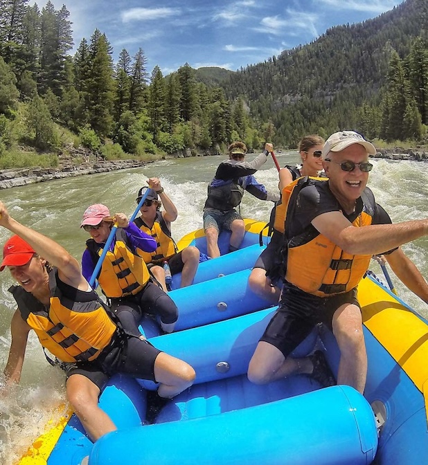a group of people on a blue and yellow raft