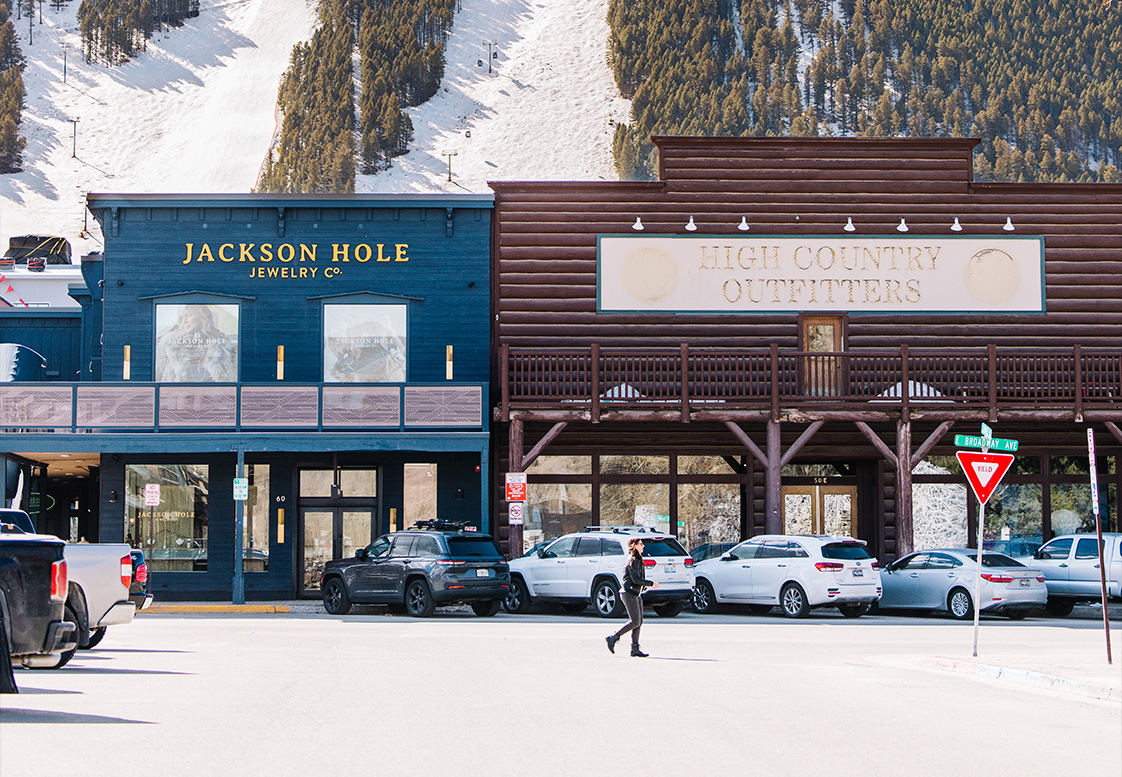 a woman walking in front of a store