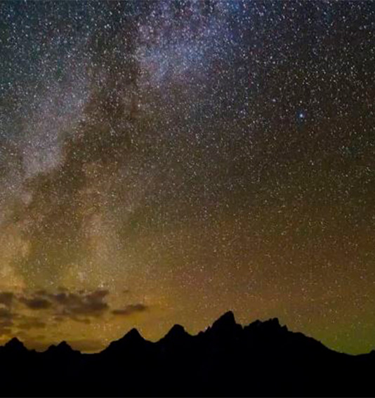 a starry sky over mountains