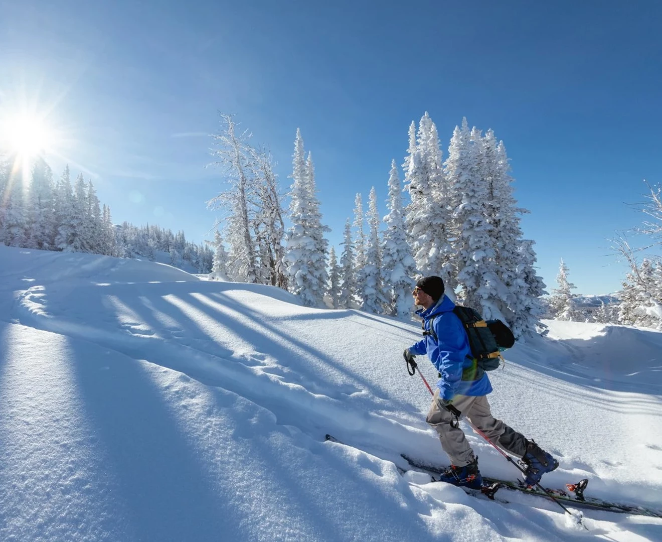 a man skiing down a snowy hill