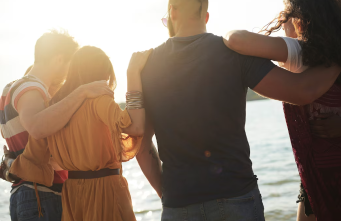 a group of people standing on a beach