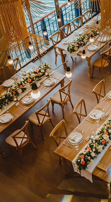 a long table set with flowers and plates