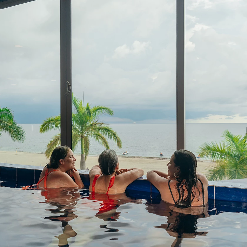 a group of women in a pool looking out a window