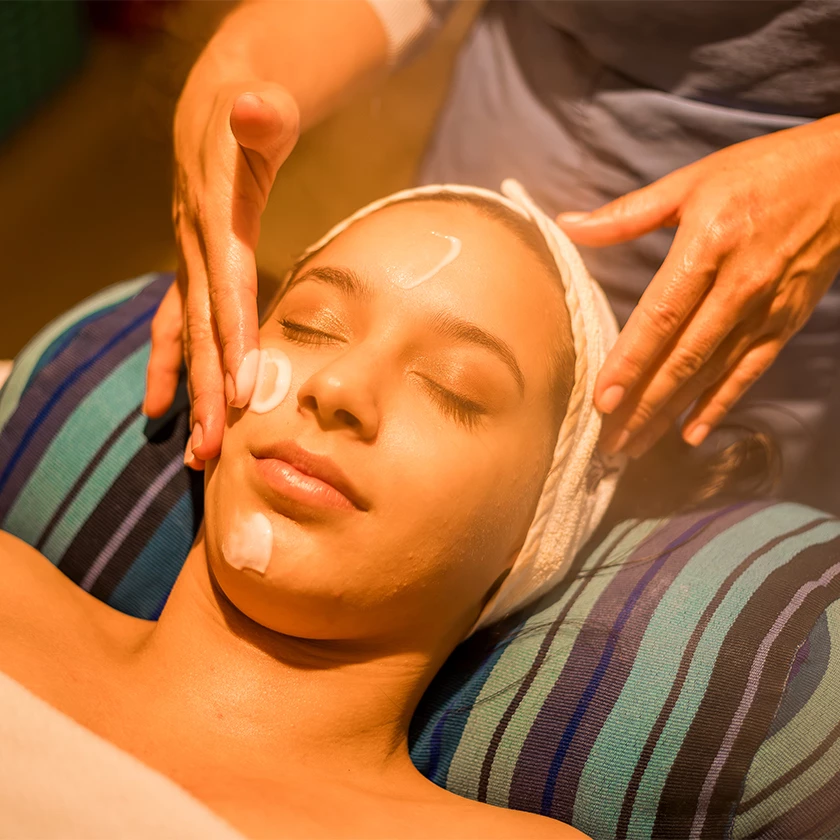a woman lying down with a towel around her head