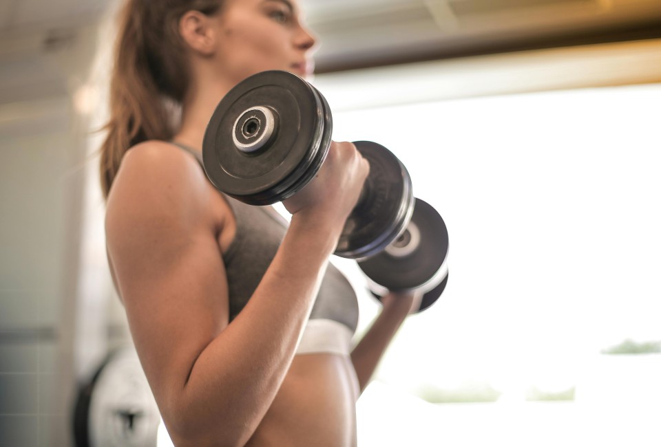 a woman lifting weights in a gym