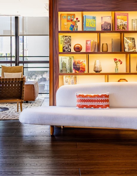 a room with a couch and bookshelf