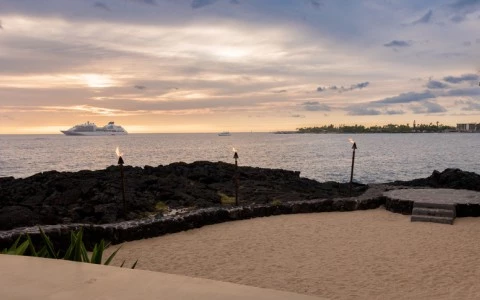 a beach with torches and a body of water