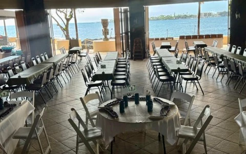 a room with tables and chairs and a large window