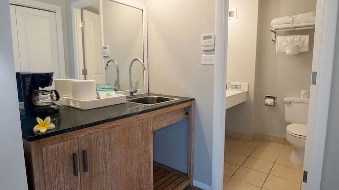 bathroom with sink outside and separate space for the toilet
