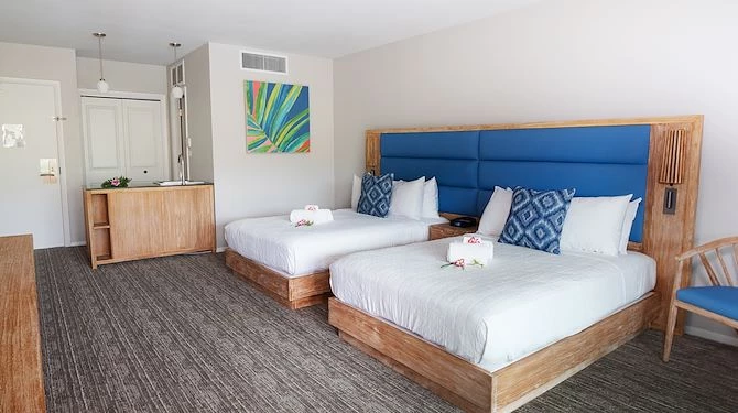 double beds with blue and wooden bed frame and blue cushions