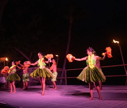 a group of people in clothing dancing on a stage