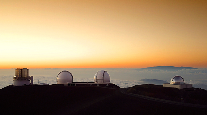 a two white domes on a mountain