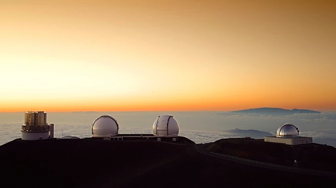 a two white domes on a mountain