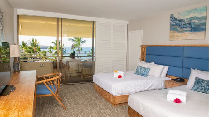 a room with two beds and a chair