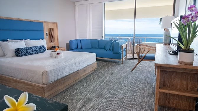 oceanfront room with king bed and a sofa
