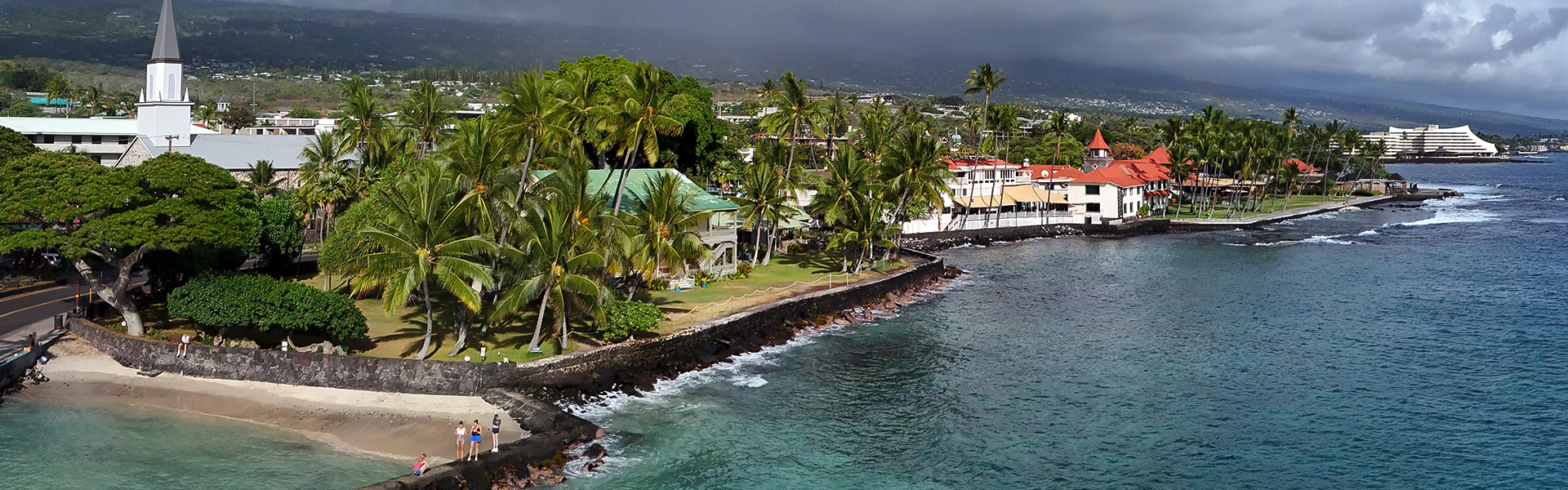 a body of water with houses and palm trees