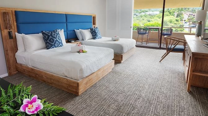 double beds with blue and wooden bed frame and blue cushions  with balcony