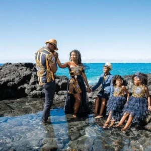engagement photos of bride groom and their children on the ocean rocka