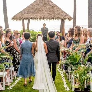 back of the bride as she is walked up with her parents